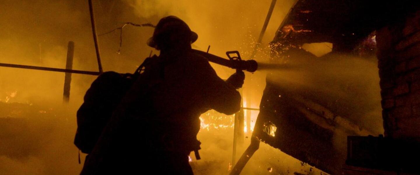 A firefighter putting out a fire.