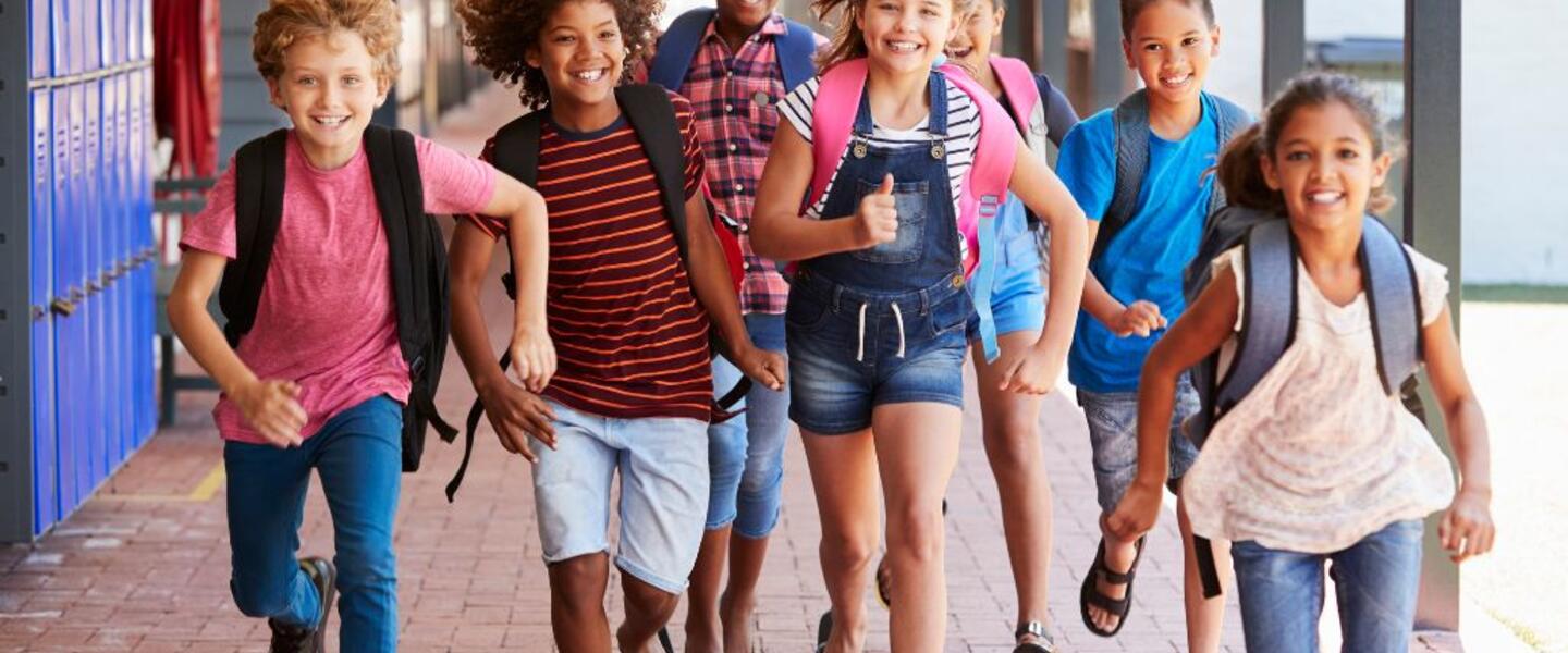 Students run in a school.