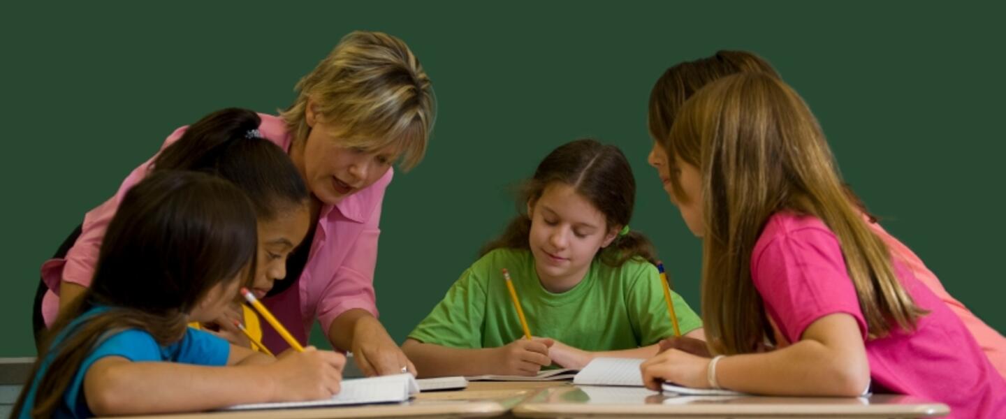 In this undated photo, a teacher works with young students in a classroom.