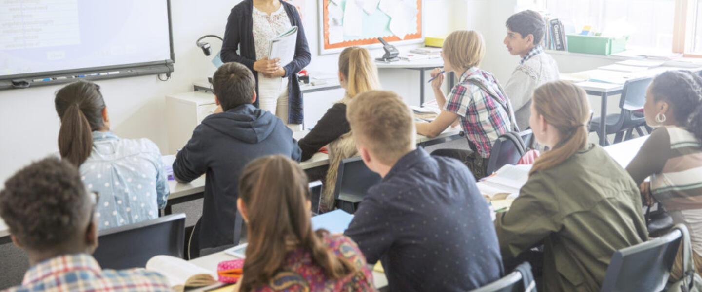 A teacher in front of a group of students