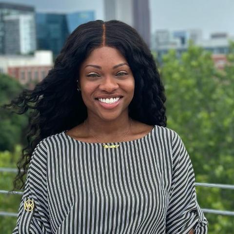 Insley Davis headshot in front of Atlanta skyline.