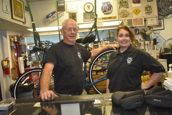 Mikki and Allen Griffin stand behind the counter of Perpetual Motion Bicycles in Carrollton. A pandemic rush on bikes has left them with few new bikes to sell, but plenty of demand for repairs. 