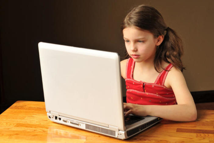 Girl sitting at computer.