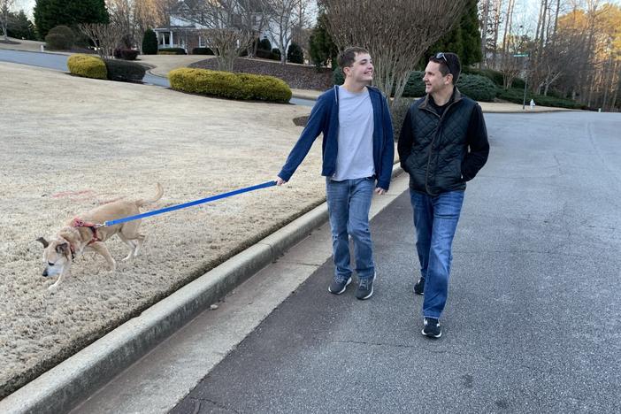 Jack Normanly and his father walk their dog.
