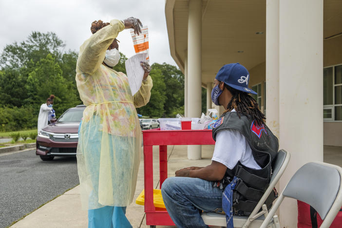 a medical professional administers a COVID-19 test