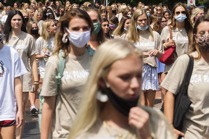 University of Georgia students participating in fall sorority rush cross Lumpkin Street in the heart of campus. 