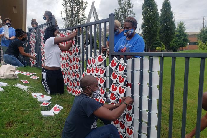 Community members gathered at the National Center for Civil and Human Rights to honor the more than 5,000 victims of COVID-19 in the state.