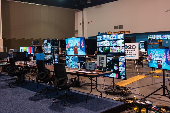 Computer and television screens crowd a large indoor space as producers prepare for the Democratic National Convention.