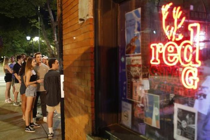 People wait to enter a bar in Athens, Georgia.