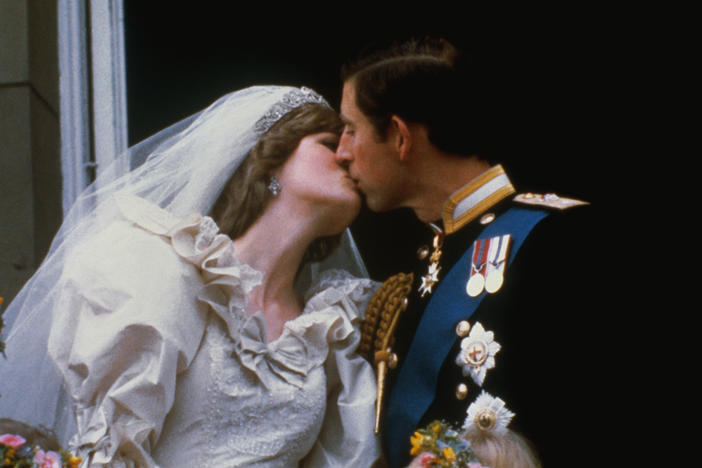 Princess Diana and Prince Charles kiss after their wedding.