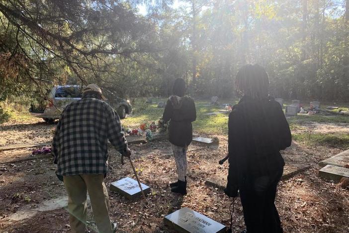 Lenton Oatman guides students from the Jessye Norman School of the Arts through Flat Rock Cemetery in Matthews, Ga., about 40 minutes south of Augusta. That's where his nephew, Charles Oatman, is buried.