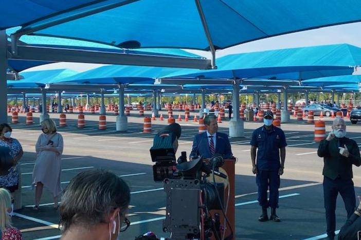 Governor Brian Kemp speaks at the opening of a new "Mega-testing" site with U.S. Surgeon General Jerome Adams looking on at Hartsfield-Jackson Airport Monday, August 10, 2020.