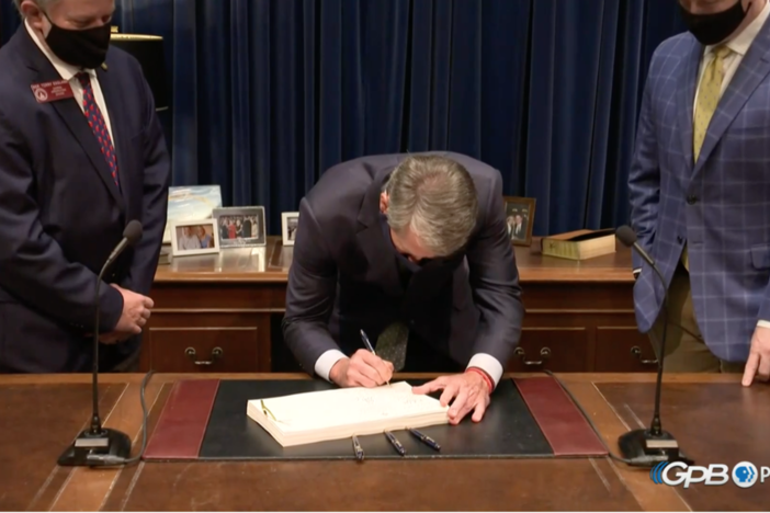 Gov. Brian Kemp signs the FY21 budget with more than $2 billion in cuts.