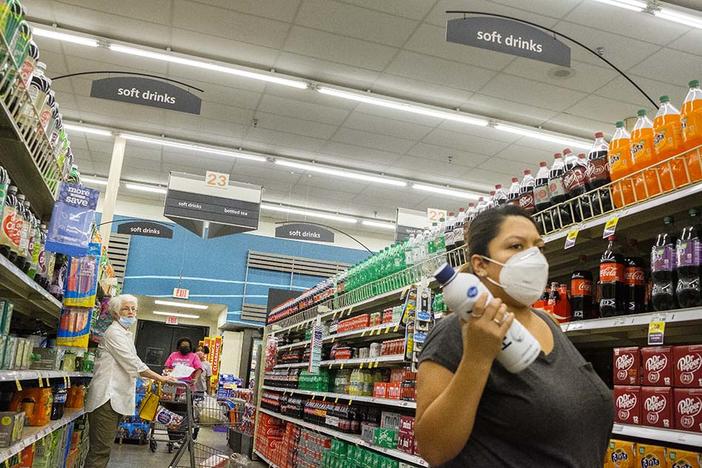 Shoppers with various takes on mask use in a grocery store in Macon on August 4, 2020. 