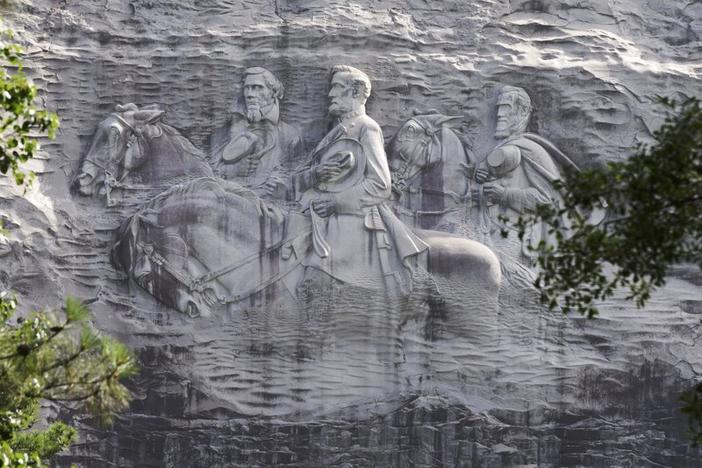 This June 23, 2015 file photo shows a carving depicting Confederate Civil War figures Stonewall Jackson, Robert E. Lee and Jefferson Davis, in Stone Mountain, Ga. The sculpture is America's largest Confederate memorial.