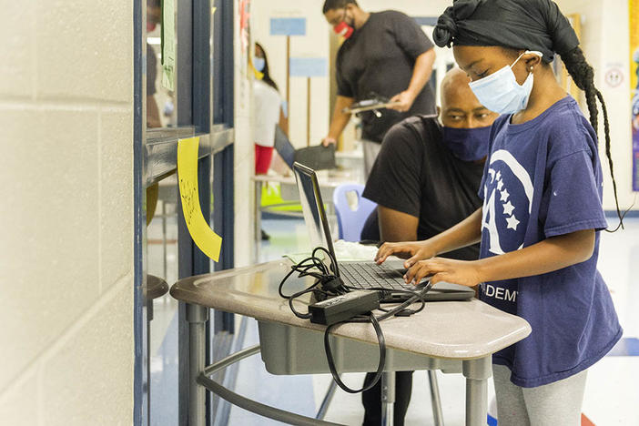 A student at Heritage Elementary School in Macon logs onto her school district supplied laptop recently. 