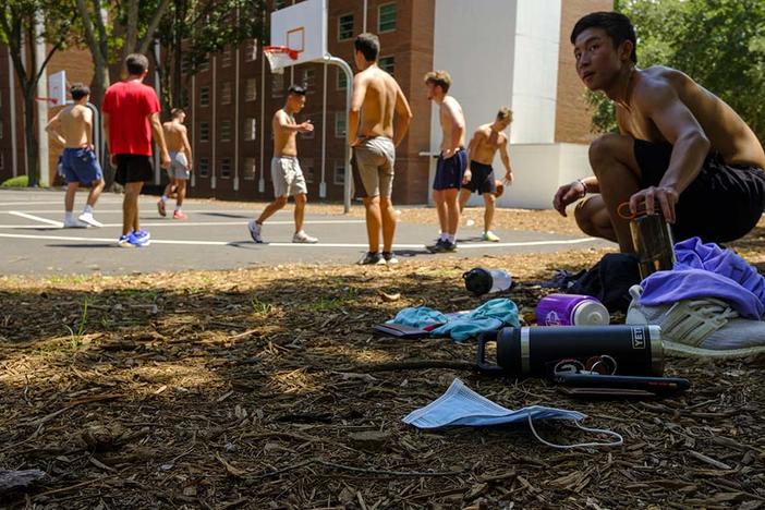 A group of University of Georgia freshmen play basketball behind the high rise dormitories on Baxter Street a few days before the start of the fall 2020 term. 