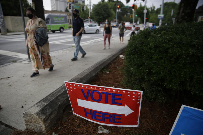 People wait in a line to vote in the Georgia's primary election at Park Tavern on Tuesday, June 9, 2020, in Atlanta.