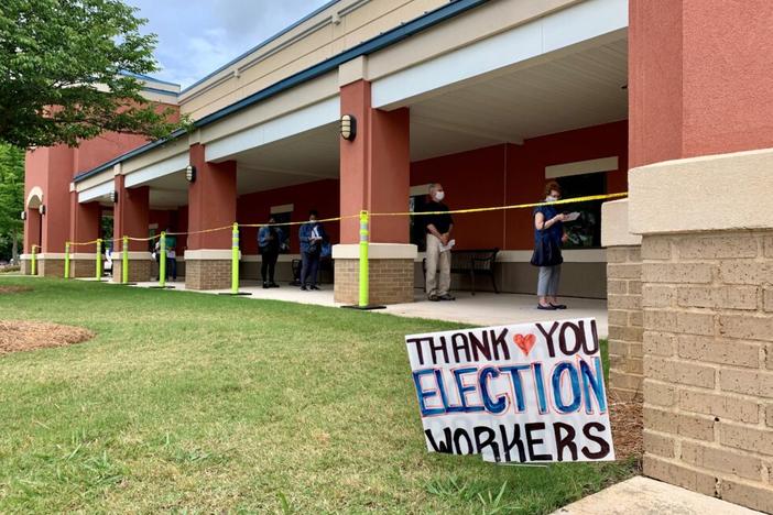 Voters wait in line at a precinct in Cobb County on May 18, 2020.