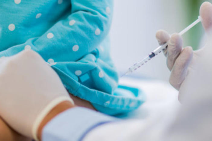 Child receiving vaccine.