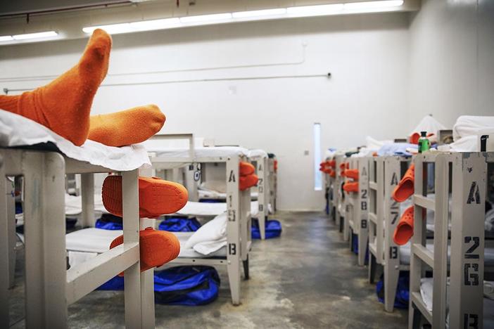 A detainee lays on a bunk in a pod at the Stewart Detention Center, Friday, Nov. 15, 2019, in Lumpkin, Ga. Coronavirus infections within the center housing roughly 1,650 male detainees have propelled Stewart County into the second worst per capita infection rate in Georgia. 