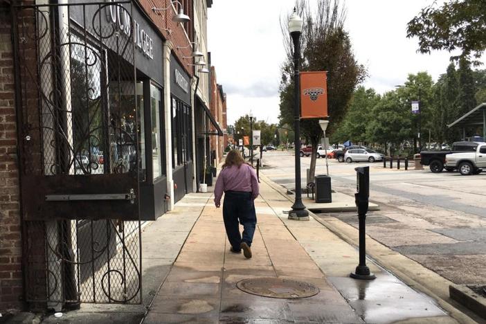 Man walks down Poplar Street in Macon