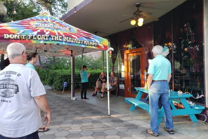 Vacationers heading to the Georgia coast for the Labor Day holiday will be at less risk of a COVID-19 infection at the beach than when they visit a local bar or restaurant. Tipsy McSway's in Brunswick, shown in late April, is now sometimes open for live music with limited seating. 