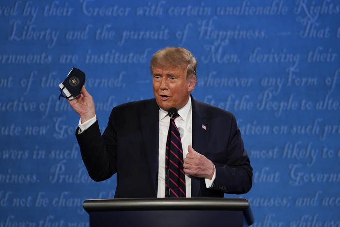 Donald Trump holds up a mask on stage during the First Presidential Debate of 2020.