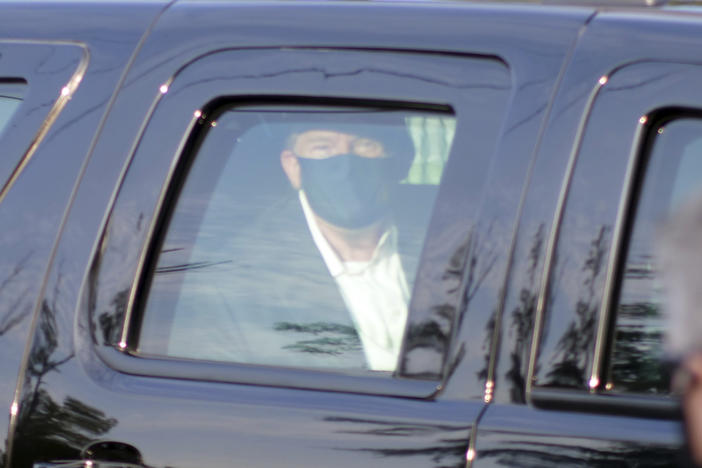 President Donald Trump drives past supporters gathered outside Walter Reed National Military Medical Center in Bethesda, Maryland, on Sunday, Oct. 4, 2020. Trump was admitted to the hospital after contracting COVID-19.