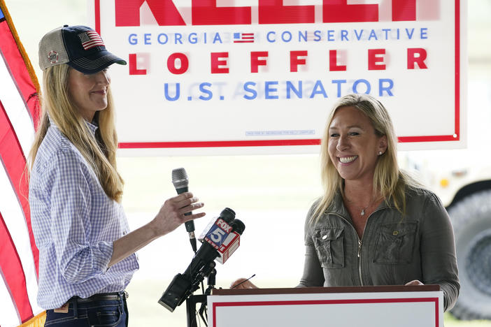 Republican Sen. Kelly Loeffler of Georgia, left, accepts an endorsement from Marjorie Taylor Greene, a congressional candidate who has embraced QAnon conspiracy theories.