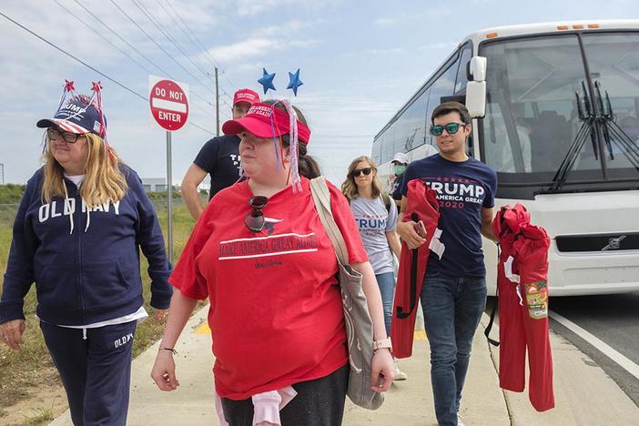 Trump supporters head into the mask-mandatory rally at the Middle Georgia Regional Airport on Friday afternoon, Oct. 16, 2020. 