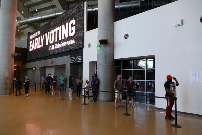 A short line of voters queues up during the first week of early voting to check in at the State Farm Arena precinct, the state's largest polling station. 