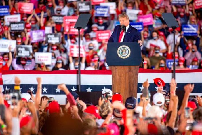President Donald Trump arrives to his Make America Great Again campaign rally cheer before his arrival at the Middle Georgia Regional Airport in Macon.