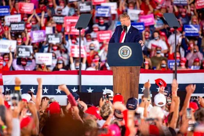 President Donald Trump arrives to his Make America Great Again campaign rally cheer before his arrival at the Middle Georgia Regional Airport in Macon. 