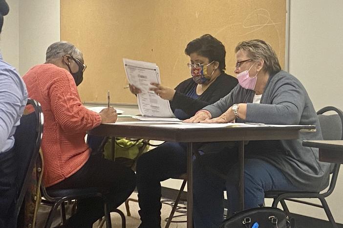 A group of election officials process ballots in Clayton county.