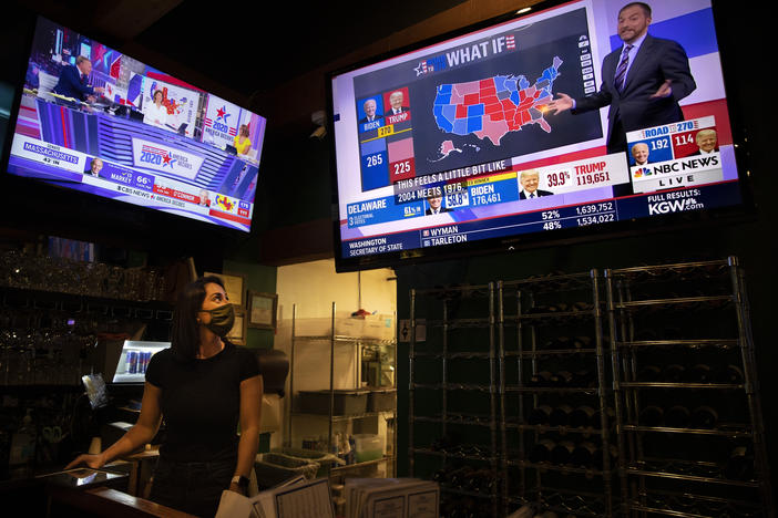 Bartender Sam Schilke watches election results on television at a bar and grill Tuesday.