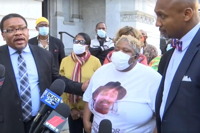 Betty Lewis, Julian Lewis's widow, stands with lawyers Francys Johnson (left) and Mawuli Davis while announcing their intent to sue the state of Georgia.