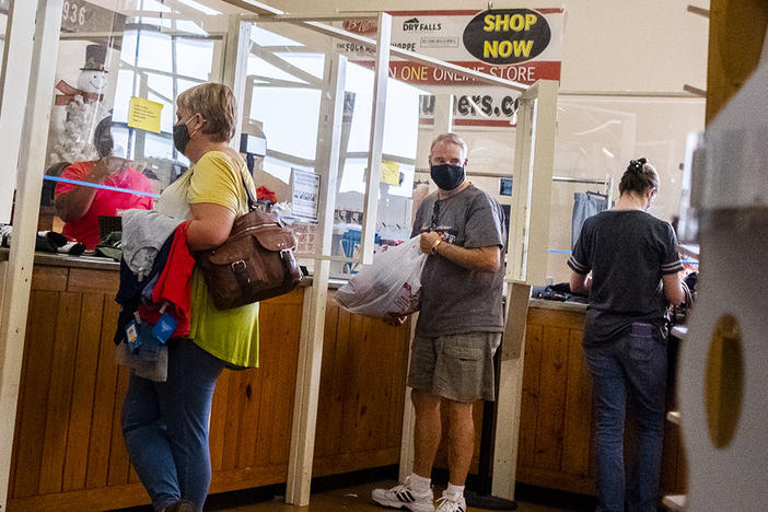 Shoppers at the checkout of the B Turner's Sock Shoppe in Macon in November. The annual economic forecast from the Terry College of Business says Georgia can climb out of the COVID-19 recession with consistent consumer spending and if it avoids more COVID-19 setbacks. 