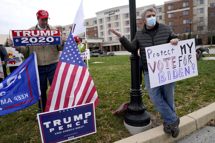 A supporter of President Donald Trump, left, and a supporter of President-elect Joe Biden.