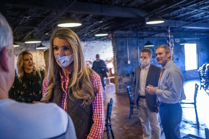 As the early in-person voting period began in the Georgia Senate runoffs, Sen. Kelly Loeffler spoke to a small group of supporters in a brew pub in Forsyth county, joined by Ohio House Rep. Jim Jordan, right.