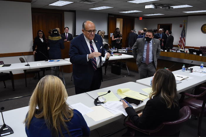 Rudy Giuliani talks with Georgia State Sens. Jen Jordan (D-Atlanta) and Elena Parent (D-Atlanta) during a break in a Georgia State Senate hearing Thursday, Dec. 3, 2020.