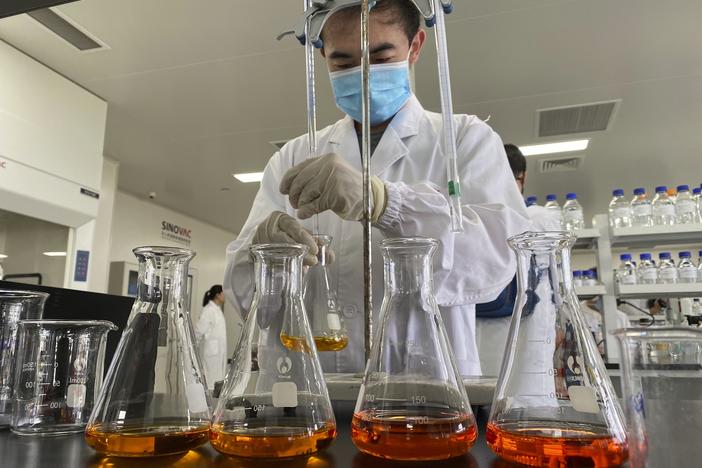 A worker works inside a lab at the SinoVac vaccine factory in Beijing on Thursday, Sept. 24, 2020. SinoVac, one of China's pharmaceutical companies behind a leading COVID-19 vaccine candidate says its vaccine will be ready by early 2021 for distribution worldwide, including the U.S.
