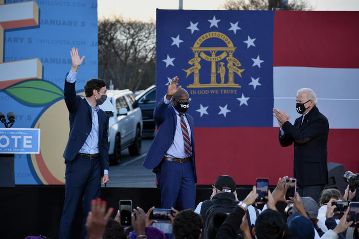 Democrats Jon Ossoff and Raphael Warnock rally with President-elect Joe Biden in Atlanta Monday.