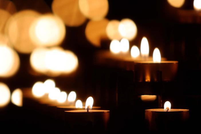 lit candles in a dark room