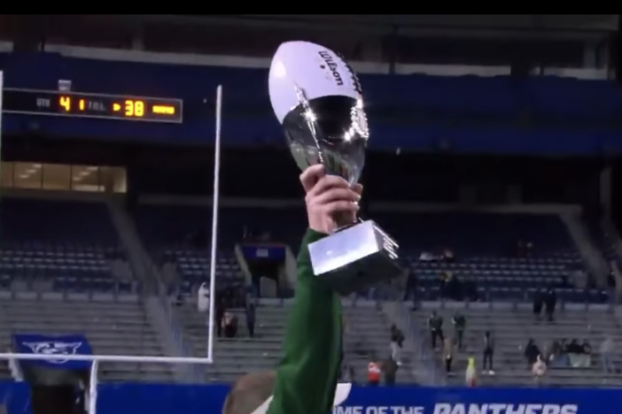 Adam Carter, coach of Grayson High School, holds the GHSA 2020 championship trophy for Class 7A.