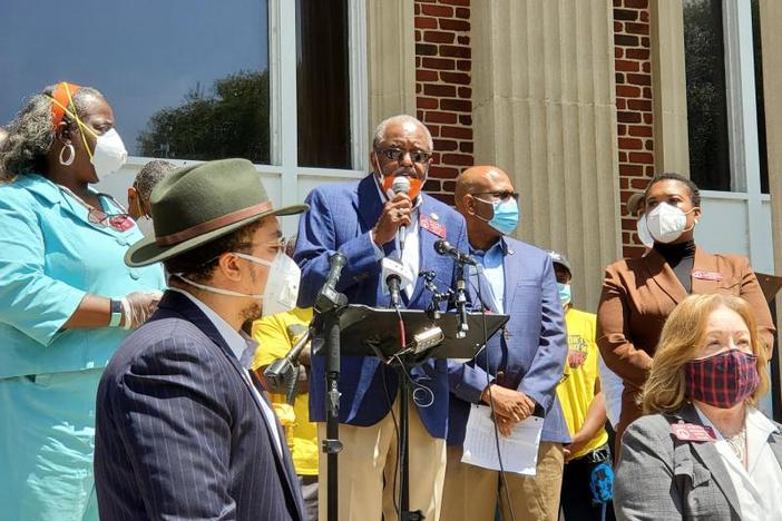 State Rep. Al Williams stands at podium May 12, 2020, during a press conference and meeting with other lawmakers in Brunswick to call for passage of a hate crimes law following the shooting death of Ahmaud Arbery.