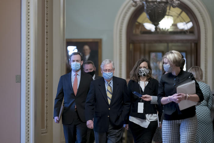 Mitch McConnell walks through the halls of Congress.