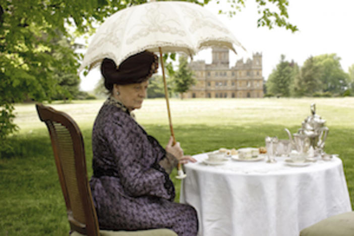 Violet, Dowager Countess of Grantham sitting outdoors. 