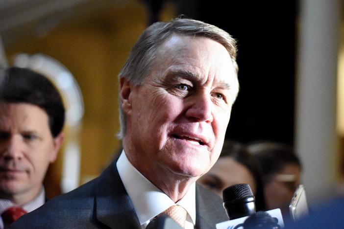 David Perdue speaks to reporters.