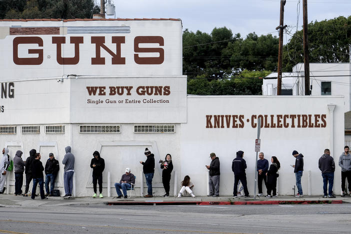 n this March 15, 2020, file photo, people wait in line to enter a gun store in Culver City, Calif